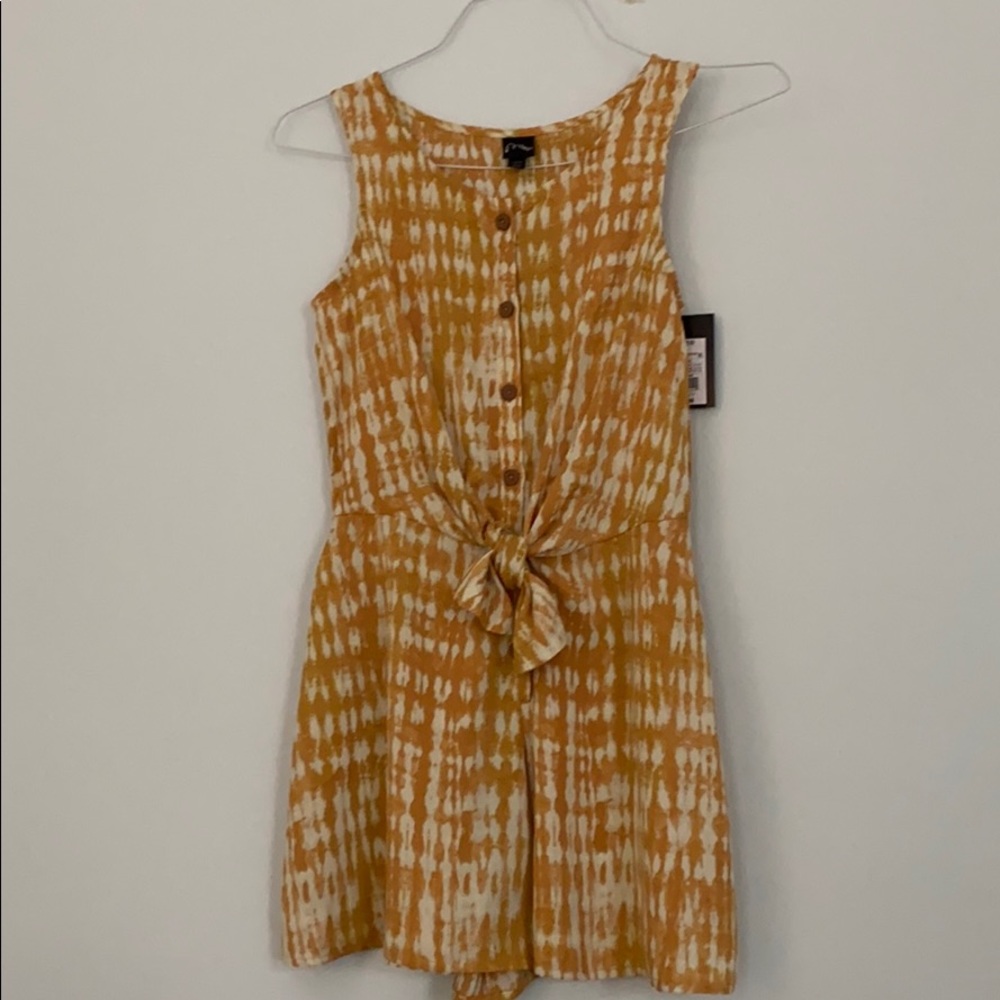 A yellow romper with tie and cream spots